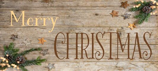 Merry Christmas / Advent background - Christmas ornament corner border banner, with fir branches, stars, pine cone and bokeh lights - Above view on a rustic wood table background.
