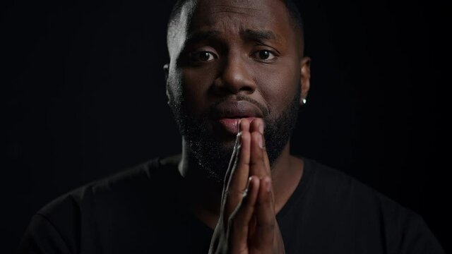 African american man begging indoors. Male person making hand gestures in studio