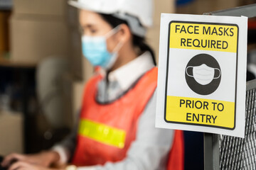 Caution sign in factory warning to industry labor worker to prevent Covid-19 Coronavirus spreading...
