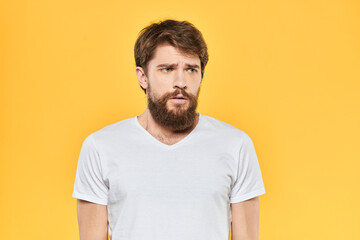 Fototapeta premium Bearded man emotions gestures with hands facial expression white t-shirt yellow background