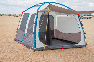Camping tent by the sea. Summer vacation at sea or in nature. Wild outdoor recreation.