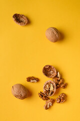 Walnuts on a bright yellow plain background
