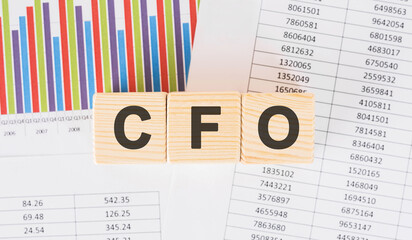 cfo word written on wood block. Faqs text on table, concept.