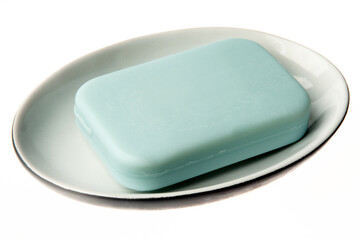 A bar of natural blue soap in a soap plate isolated on white background. Studio shot. Hygiene theme - bacteria and virus prevention