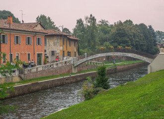 bridge and old farmhouses on the Naviglio Grande in the Lombard countryside near Milan.Italy