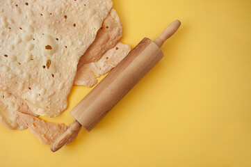 rolling pin and shortcakes on a yellow background