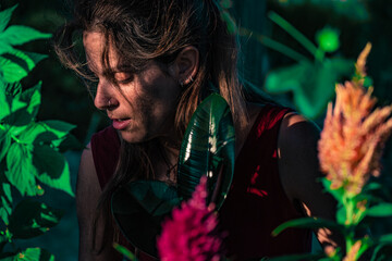 Close portrait of Caucasian woman surrounded by plants