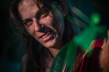 Close portrait of Caucasian woman surrounded by plants
