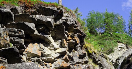 rocky, stone, steep side of the mountain against the blue sky