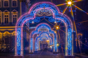 Fototapeta premium Saint Petersburg on Christmas night. Russia in winter. Christmas arches in Saint Petersburg. Glowing arches in Russian city. Lights of Christmas Petersburg. Celebrating the new year in Russia.