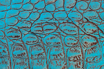Texture of genuine leather with embossed scales reptiles, turquoise color, trendy pattern, natural background