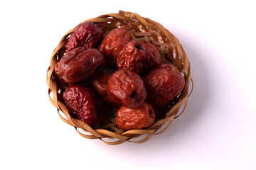 Dried jujube in a plate on a white background