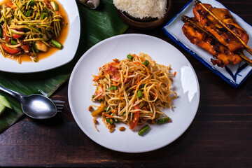 Papaya salad with grilled chicken papaya, popular food in Thailand.