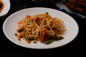 Papaya salad with grilled chicken papaya, popular food in Thailand.