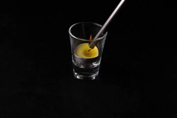 The check light is lighting a candle in the glass