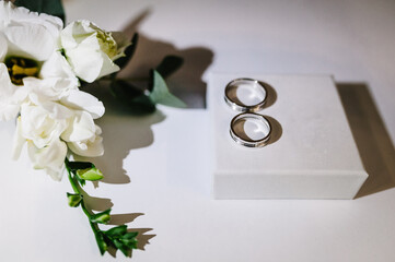 Engagement. Rings groom and bride. Beautiful bouquet flower on white wooden table. Wedding bouquet. Love concept.