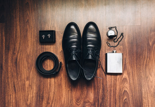 Wedding and gentlemanly men set: leather shoes, belt, cufflinks, vintage pocket watch. The morning of the groom. Business, wealth, details. Photography and concept.