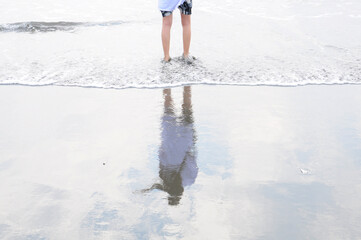 Girl standing on the beach.