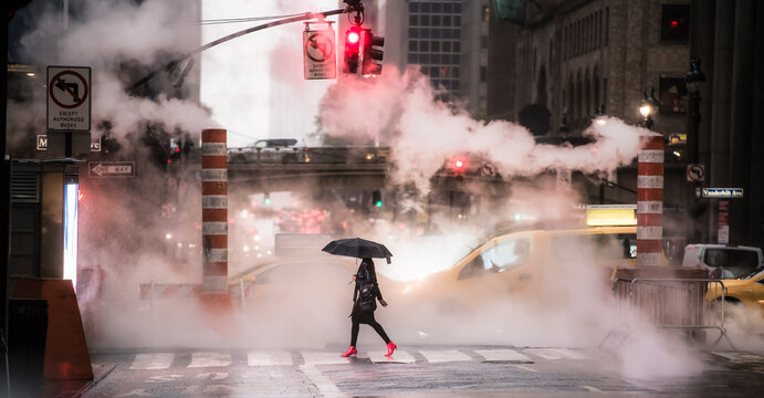 A woman wearing red high heels is crossing the 42nd street in Manhattan during the Covid-19 outbreak. Manhattan, New York City, United States.