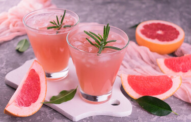 
Cocktail with grapefruit and rosemary. Refreshing drink with ice.