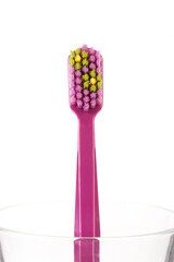 Tooth brushes in glass, isolated on white