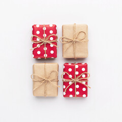 Christmas gifts composition. New year flatly with red dotted and craft gifts at grey background. Xmas concept.