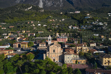 Fototapeta na wymiar Malcesine town, Lake Garda, Italy. Aerial panoramic view of Parish of Santo Stefano, Malcesine town. Italian resort on Lake Garda, Monte Baldo.