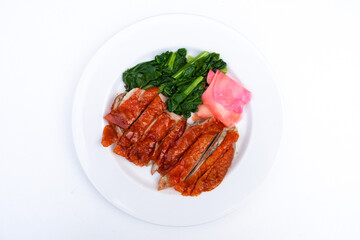 Roasted duck or peking duck and vegetables, Chinese style on white background.