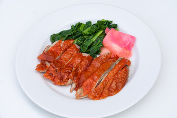Roasted duck or peking duck and vegetables, Chinese style on white background.