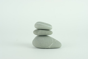 Stack of three grey beach rocks or stones