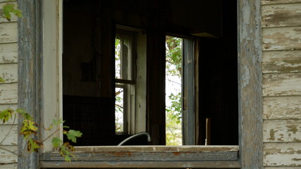 Fototapeta na wymiar Old abandoned farmhouse open window