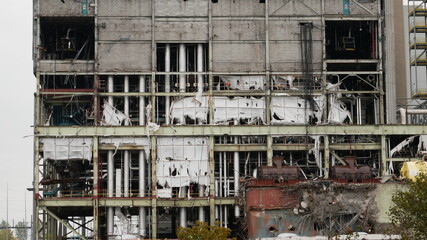Old industrial steel building being demolished and in decay