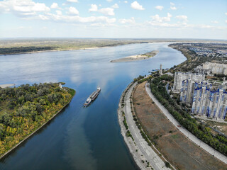 Cargo transportation by river transport. A cargo ship with a barge left for the Volga River. River fleet.