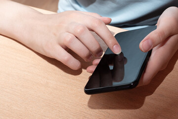 A man holding a smartphone with a black display, a female hand points to a black screen display phone