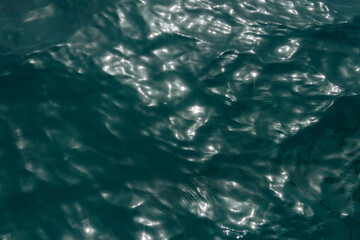 Colorful lights bokeh effect on the water. Abstract light bokeh background. Blurry lights. Glitter 