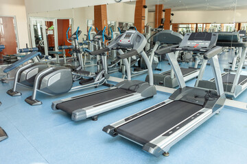 Fototapeta na wymiar Interior of modern gym fitness room with treadmills