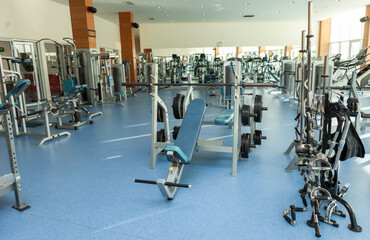 Fototapeta na wymiar Interior of modern gym fitness room with sports and fitness equipment