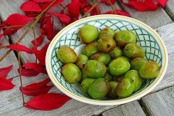 Bowl of green baby kiwi berries actinidia arguta