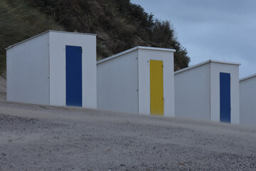 Fototapeta na wymiar bath cabins on Cadzand windy beach