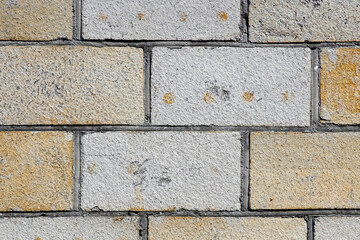 Fototapeta premium The white and yellow brick wall closeup