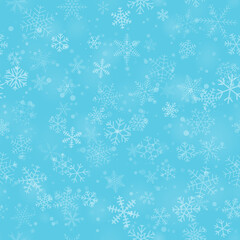 Christmas seamless pattern of snowflakes of different shapes, sizes and transparency, on light blue background