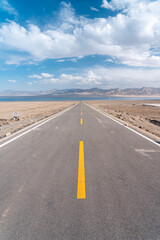 road in the desert to the lake 