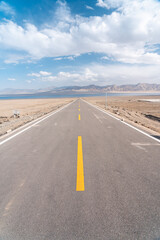 road in the desert to the lake 