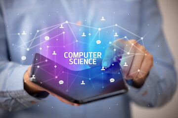 Businessman holding a foldable smartphone with COMPUTER SCIENCE inscription, new technology concept