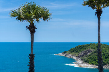 The seascape part of the island in the mid summer holiday in Phuket Thailand Asia with the deep blue ocean and clear sky as the background, natural tall tropical palm trees on the shore