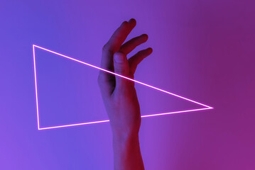 Female hand. mystical concept. Creative pop art pink blue neon color. Trendy gradient illumination. Night light