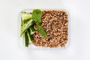 Buckwheat and cucumber in a lunch box. Healthy lunch to go