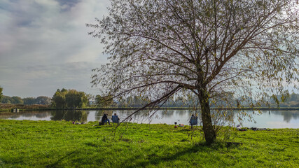 Sunny day on the perfect lake. Autumn lake with reflection on the water. Cloudy sky in the sunny day.