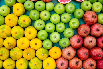 Top view fruits lined symmetrically on isolated white background