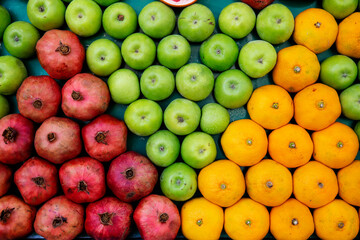 Top view fruits lined symmetrically on isolated white background